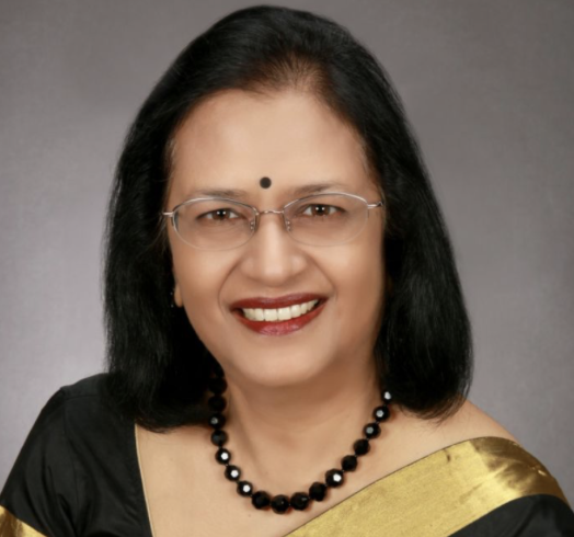 Smiling woman with dark hair, bindi, and glasses.